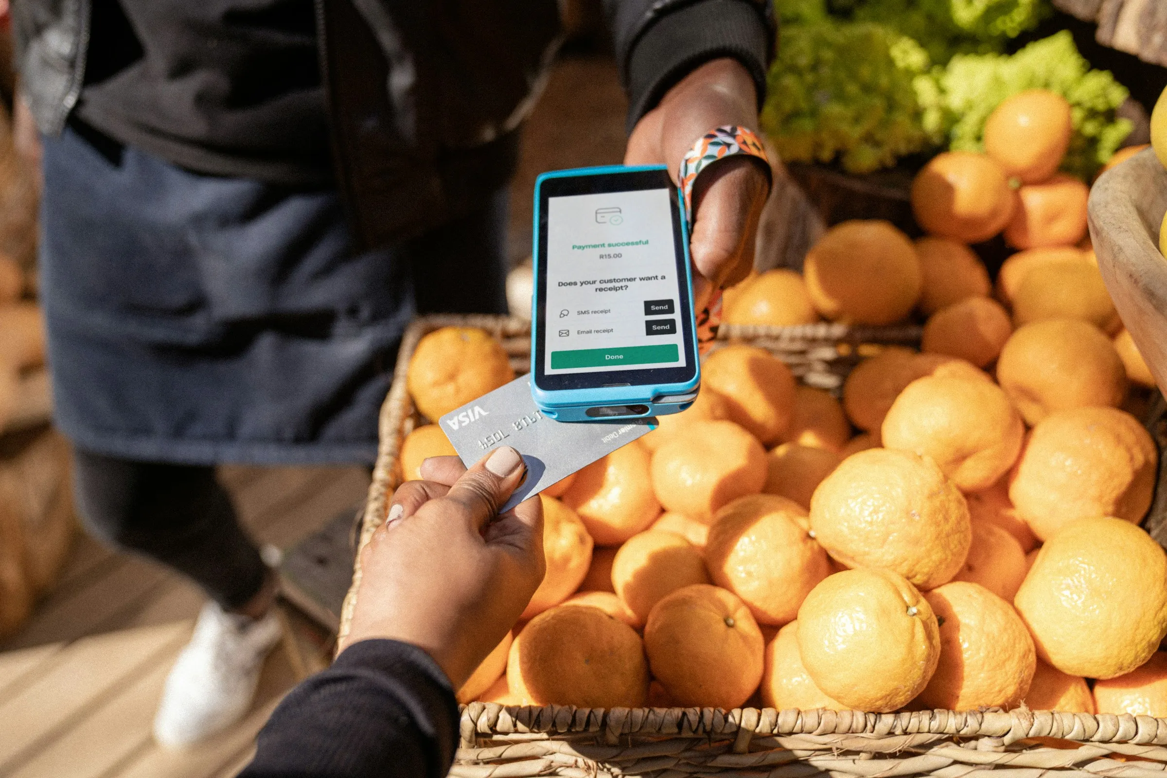 A trader confirming a mobile payment at a market stall